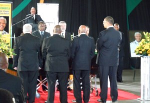 Guard of honour at Mandela's coffin: Sinn Féin's Richard McAuley (left) and Gerry Adams, with Urko Aiatza of the Basque organisation SORTU, as President Zuma addresses the crowd