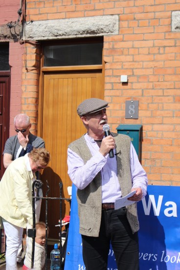 Diarmuid Breatnach singing "Felons of Our Land" outside former home of Walter Carpenter. (Photo East Wall History Group)