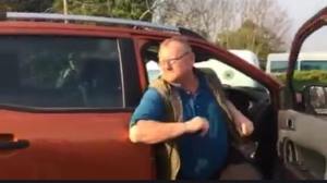 Mr. 'Rowdy' Nolan leaving his car after backing into Mr. McGrath and just before his foray into the protesters.