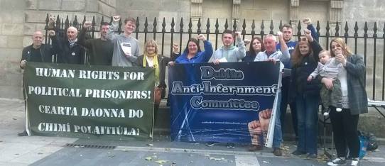Anti-internment campaigners line up for a photo with clenched fists (Photo: Ian O'Kelly)