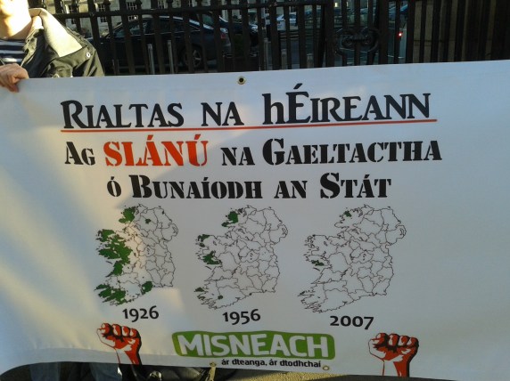 Map on Misneach banner illustrates the decline of areas where Irish is a living community language under the Irish state's administration. (Photo D.Breatnach)