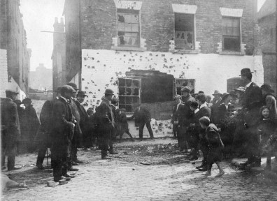 The `"white house`" in Henry Street, facing Moore Lane, showing the British Army machine-gun and rifle bullet damage from Parnell Street and from the Rotunda tower. The GPO Garrison had to cross this opening to proceed onwards to Moore St (to the right).