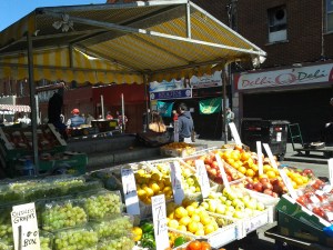 View of the campaign table through fruit stall on a sunny Saturday in Moore St in June 2015 (Photo D.Breatnach)